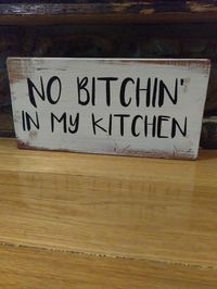 Sign may have original nail holes and Knott's that gives it a rustic look. No bitchen' in my kitchen. Hand made in the USA. I have painted and sanded for a distressed look.