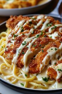 Ingredients:  2 large chicken breasts, boneless and skinless 1 cup all-purpose flour 2 large eggs, beaten 1½ cups panko breadcrumbs ½ cup grated Parmesan cheese 1 tsp garlic powder 1 tsp Italian seasoning ½ tsp salt and pepper (each) 3 tbsp olive oil 12 oz fettuccine pasta, cooked 2 cups heavy cream 1½ cups grated Parmesan cheese (for Alfredo sauce) 3 garlic cloves, minced 3 tbsp unsalted butter Fresh parsley for garnish Instructions:  Season chicken breasts with salt, pepper, garlic powder, and Italian seasoning. Dredge chicken in flour, dip in eggs, then coat with panko and Parmesan mixture. Heat olive oil in a skillet and cook chicken 4-5 minutes per side until crispy and golden. In a pan, melt butter, add minced garlic, and sauté for 1 minute. Stir in heavy cream and simmer.