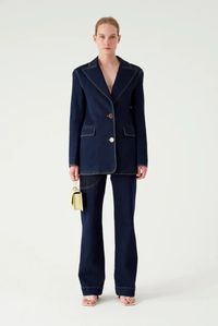 The rejina pyo mina blazer in denim dark indigo is a fitted single-breasted blazer crafted in gots certified organic cotton, featuring front pockets and a back slit. fully lined.