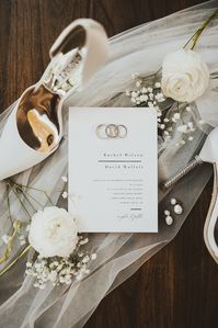 A bride and grooms wedding details are what sets the tone for the aesthetic of a wedding day. Choosing how to structure a flat lay is so important to the story telling element of a wedding photo gallery.  This was a chic and romantic winery wedding with white florals & elements of babys breath.  The bride had pearl drop earrings and Badgley Mischka pointed white wedding shoes. 