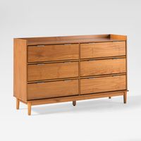 Stylish, luxurious, and practical, Saracina Home's Mid-Century Modern Solid Wood 6-Drawer Double Dresser gives you a little bit of everything. Raised, tapered legs give this piece its nostalgic charm, while the six drawers give contemporary convenience. A raised lip around the top surface frames your décor and keeps trinkets safely in place. Constructed with solid pine wood that is responsibly sourced from renewable forests, this chest of drawers adds one more sustainable purchase to your bedroo