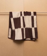 Inspired by traditional Ikat weaving techniques, this ultra-sophisticated bath towel is fully reversible. The artisanal pattern is comprised of two tones in a low-key landscape of walnut and cream. The heavy double yarn is gratifyingly durable and maximizes on comfort, framed with a modern cotton trim. This towel absorbs and dries with ease thanks to the sumptuous surface area that forms an exceptionally even pile. Designed by the Amsterdam Based homeware brand, Autumn Sonata.