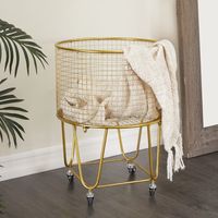 Create a calming, organized space with style. Filled with shoes, laundry, blankets and more, these storage carts are a stylish way to store your stuff. This industrial rolling cart is a multifunctional home piece that can serve as a laundry hamper, pillow and blanket basket, cart , or planter stand. This item ships in 1 carton. Suitable for indoor use only. Maximum weight limit is 20 lbs. This is a single storage cart. Industrial style. DecMode Gold Metal Deep Set Metal Mesh Laundry Basket Stora