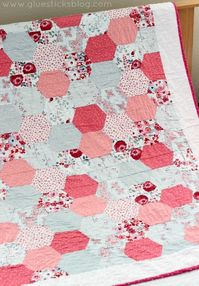 Simple Hexagon Quilt: Half hexagons are stitched together in strips to create the classic hexagon quilt pattern. Bold, beautiful, and perfect for beginners.