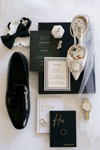 The stage was set for an elegant, black and white affair with a stunning contemporary invitation suite with mixed fonts. Vow booklets featured a delicate gold font detail. #weddinginvites #vowbooks #weddingshoes #weddingaccessories #weddingjewelry