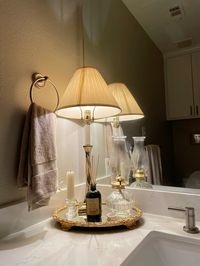 I lesrned this devor trick from my grandmother. Have extra counter space? Find a lamp! It makes the lighting so much better for guests and keeps your bathroom looking beautifully aesthetic!