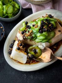 A simple cold silken tofu recipe elevated with a savoury sauce, fried garlic, fermented black beans, and topped with pickled cucumber. It is truly one of the easiest Chinese tofu side dishes you can prepare that is utterly delicious to eat.