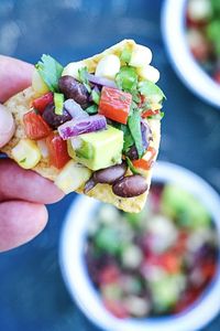 Black Bean and Corn Salsa is a no-cook, 10-minute salsa with whole black beans, sweet corn, bell peppers, red onion, and avocado. Cilantro, jalapeño, and lime give it authentic Mexican flavors. Grab the chips or scoop black bean corn salsa over your favorite Mexican foods #blackbeansalsa #avocado #salsa #appetizer #gameday #blackbeansalsa #partyfood