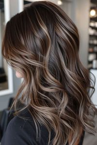 In this brown hair color, the deep and enigmatic midnight brown is complemented by subtle beige blonde highlights. Click here to see more brown hair colors with blonde highlights.