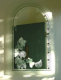 Violets. Sandblast and acid etch on mirror. Virginia Davidson