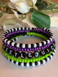 5 layer memory wire Halloween inspired Black, white, lime green and vibrant purple Czech seed beads used to make this multi wrap bracelet.  Bracelet can also be made without the letters/word shown, and would be replaced with all black seed beads. See last pictures for example. Memory wire keeps its shape even after stretched out or twisted. The wire is flexible,  easily wraps around your wrist, and doesn't need a clasp for closure. Typically fits comfortably on wrists up to ~ 7.25".  Free Shippi