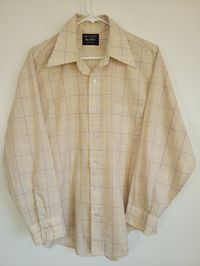 Here's a Vintage 1970s JCPenney brown/tan plaid architect grid poly/cotton long sleeve shirt! Has the pointy collar. Measured men's chest 48". White buttons, yellow accents. Still has the printed info on the bottom hem! Lightweight, somewhat translucent material too. This shirt is pristine and was clearly never worn or washed! Please see our other listings for more vintage garments with new items added nearly daily. PLEASE check the measurements as vintage clothing sizes may not comparable to contemporary sizes. Measurements: Label size: none present Shoulder-to-shoulder: 20" Chest across: 24" Sleeve from shoulder: 22" Length in back from base of collar: 30" Pete's Obsolete is smoke-free. We present garments as honestly as possible and point out any known flaws. We leave cleaning and/or re