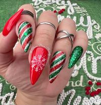 Handmade Red and Green Christmas Nails, Sparkling Winter Press on Nails, Reusable Glue on Nails, Candy Cane Nails, Snowflakes Nails Model: Long Flat Stiletto Please read full description below. This set features:  Handcrafted red and green winter nails Index & Ring - Glitter green red and silver candy cane design Middle - handpainted white snowflake on a red background Glossy finish Gel polish. I offer quality handcrafted press on nails designed with quality gel polish. This set will give you a