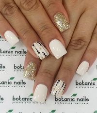 White and gold with a touch of black looks fantastic and go with almost any colored dress. Pamper your nails with this neat design.