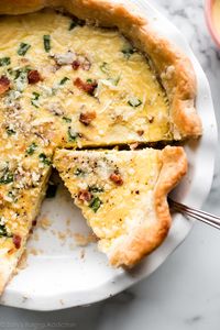 Learn how to make the perfect quiche recipe with homemade pie crust, eggs, heavy cream, and your favorite add-ins like bacon, ham, hollandaise sauce, and more! Recipe on sallysbakingaddiction.com