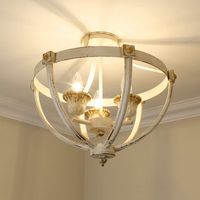 This 3-light semi-flush mount showcases an open design and a weathered finish for plenty of farmhouse charm in your living room or hallway. Its open, bowl-shaped frame is crafted from steel, and it features an antique ivory finish with a rusted gold patina. The candelabra in the middle of the shade accommodates three candle-style bulbs up to 60W, which are sold separately. We love that it's rated for damp locations, so it's safe to install in your bathroom. Plus, this light is compatible with a