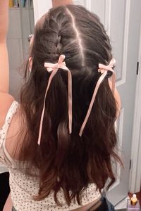 pink girly coquette bow clips in french braid half up half down pigtail hairstyle