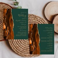 The left-hand edge of this elegant modern wedding program features a burnt orange and rust watercolor agate border trimmed with faux gold glitter. The customizable text combines gold-colored handwriting and copperplate fonts on a dark green background.