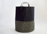 This large basket is great for storing and carrying laundry, towels, toys, knitting/craft projects, and more.  Made with a navy and green linen and lined with natural Cotton Canvas. Has dark brown leather handles attached with antique brass rivets. Hand printed with metallic gold