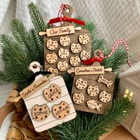 This personalized family ornament looks like freshly baked cookies that just came out of the oven! Choose up to 12 names to be on the cookies including your pets. This ornament makes for a very cute and unique family gift, especially for the grandmas and bakers in your life! The ornament is made out of wood, and is laser cut, engraved and stained on the front AND back.  ORNAMENT SIZE: Small (0-7 names): 3" x 4.5" Large (8-12 names): 3.5" x 5.5" PERSONALIZATION: * Rolling pin: Please keep to arou