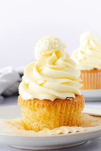 Moist, fluffy and bursting with zingyness these lemon white chocolate cupcakes are a lemon lover's dream! Filled with a zesty lemon curd and topped with an incredible smooth and creamy buttercream, you'll love the refreshing citrus flavour in every bite. #cupcakes #lemoncupcakes #lemon #whitechocolate #cupcakerecipe #cupcake #lemoncake #lemonwhitechocolate