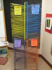 My drying rack was originally all light blue. I teach four classes a day, so I divided it up and spray painted each section to keep my student's artwork better organized.