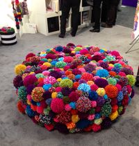 Spotted this oversized ottoman festooned with pom-poms at Toy Fair 2014. No link, just photo.