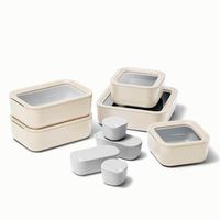 The Food Storage Set includes everything you need to safely and neatly store your leftovers. These BPA-free glass containers are coated with a non-toxic ceramic finish to ensure an easy cleanup after every use. The set features (2) Small Containers, (2) Medium Containers, (1) Large Container, (2) Dot inserts, (2) Dash inserts, and (2) Straps, all with individual lids and storage organizers to keep your cabinet tidy. Color: Cream.