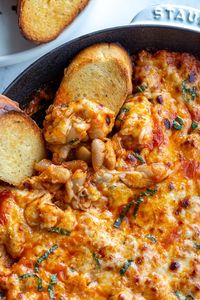 This Cheesy White Bean Tomato Bake ALL comes together in one skillet and makes the perfect appetizer, side dish OR even a complete meal (which is how I love it!). It's cheesy and delicious and SO FILLING!