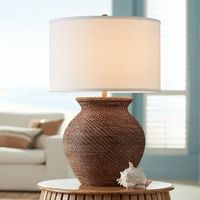 Created from brown weave finish rattan-look materials, the base of this jar table lamp invokes a coastal feel with exotic inspiration. A generous jar silhouette offers an expressive charm that embellishes a casual setting in a beach or cabin. Topped with a soft off-white linen drum shade, this tasteful lamp is the perfect choice for a main living space or a freshly styled bedroom. Available for Online Purchase Only. Assembly required. This product ships direct from the manufacturer, so RC Willey