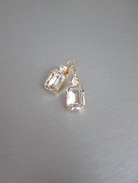 "These beautiful elegant earrings are made with fancy emerald cut and round Swarovski crystals. Available in gold, rose gold and silver finish. Matching necklaces an the bracelet are also available and they are shown in the last two photos. - 1 3/8\" long from the top of the ear wire to the bottom of the earring and 1/2\" wide - Leverback - For the matching bracelet please take a look here: https://www.etsy.com/listing/754440549/swarovski-crystal-bridal-bracelet-gold?ref=shop_home_active_19&