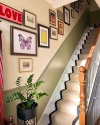 gallery wall ✨... when we started planning the gallery wall up the staircase, we used brown paper and cut around the frames so we could play around with the layout before sticking nails into the wall ;) it’s far from complete but it’s getting there. if you have a closer look, you’ll see bow at the top of the stairs giving you a big monday morning smile 😹 have a good one x wall colour is lime white and lichen @farrowandball #gallerywall #stairrunner #staircase #stairgallery #gallerywallde