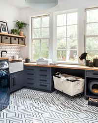 Cabinets are painted Benjamin Moore Day's End and walls are painted Calm. Design by Studio Monroe