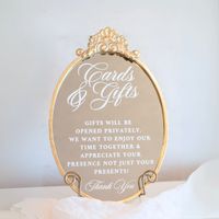 Wedding Gifts and Cards Sign | Modern Wedding Signage | Guest Book Sign | Elegant Wedding Decor | Gift Table Sign | Bridal Shower Sign Your Cards & Gifts area at your wedding will look complete with this stunning gold oval mirror sign right next to it. This wedding mirror easily allows for guests to see where they should drop their presents and blessings when entering the ceremony, reception, or other celebration. With its timeless accent of an ornate gold fleuron, this mirror is the sophisticat