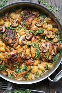 Creamy Chicken Gnocchi with Spinach and Mushrooms in a stainless steel pan.