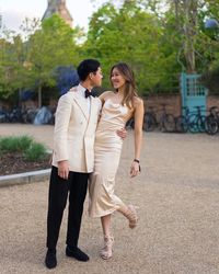 Buzz Tang and his wife Vanessa. Buzz is wearing a double breasted dinner jacket in ivory.