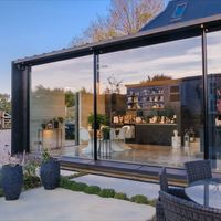 These large patio door sliders create an entire wall of glass to this sustainable barn conversion. The patio door sliders fill the entire rear elevation of the barn extension and create a direct link from the open plan kitchen to the rear patio. The large patio door sliders were from IQ and created bespoke for the project. Click on the link to see more images of this project.