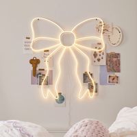 Tie your room together with this whimsical neon sign. White LED bulbs trace a glowing bow silhouette, adding an enchanting accent to your sleep space. Designed exclusively for Pottery Barn Teen by lifestyle brand LoveShackFancy. KEY PRODUCT POINTS Made of iron, plastic and LED. Plug-in. 5 volts. Mounting hardware included; screw. Imported.