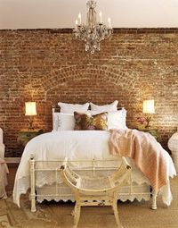 Master bedroom with brick accent wall, shabby chic white country farmhouse bedding and design - looks a little rustic boho to me... LOVE the bedroom chandelier idea too.