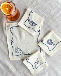 Happy long weekend!🧡 We hope you are celebrating with an Aperol Spritz (or a glass of wine from @chinchincreemore !) and some appetizers paired with our embroidered napkin sets✨ The perfect gift for nights at a friend’s house. Did you know Laurie drew the illustrations, Tessa digitalized them and we had them embroidered? Each set (Apero, Veggies, Hi!, and Bathers) come with 4 unique illustrations #tablescape #hostessgift #summerdinner #summerevenings #summerparty #cockatil #cocktailparty #ap...