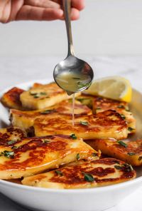 This fried Honey Glazed Halloumi recipe includes the combination of adding honey, lemon juice and thyme which is a flavour bomb with every bite! #cheese #sidedish #appetizer