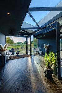 A Grade II listed barn is given a new lease of life with glazed rear extension and large glass rooflight within the deepest part of the building to allow natural light to flood in for comfort and energy efficiency in this sustainable renovation. Click on the link to read about the structural glazed roof within this sustainable barn.