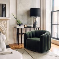 Channel-tufted in rich green velvet, deco-inspired swivel chair makes a vintage statement wherever it sits. Designed by VUUE, the chair looks good from every angle. CB2 exclusive.