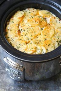 Slow Cooker Cheesy Scalloped Potatoes - This crockpot version of scalloped potatoes is so EASY, creamy, tender and cheesy! And it frees up your oven space!