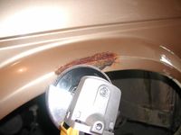 I drive a 1985 VW Golf (diesel), and it's in pretty good condition for being 21 years old. There are three spots on the front left fender that have rust on them. Someone had hit the car and the paint came off, so it became rusty. These spots are not only an eye sore, but they are sure to spread in the salty Nebraska winters. My goal in fixing these was function, and not so much glamour. The car is kind of a beater, so I wasn't too concerned with making it look perfect. As long as the ...