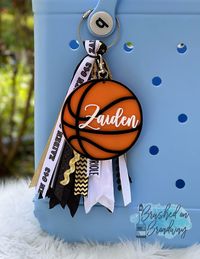 "This listing is for one Laser cut Basketball Bag Tag.  I can do any color combo for the ball and name, if you don't see the color you want in the drop down menu leave that information in the personalization box Each tag is cut out of 1/8 inch acrylic and is completely waterproof, Each color is its own layer and then glued together making the total depth of the charm 1/2 inch. The charm is 4 inches big Each tag comes on a swivel hook to easily switch it between bags.  **The \"charm only\" option