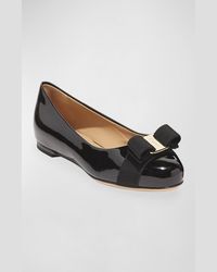 Salvatore Ferragamo "Varina" ballerina flats in patent leather Signature Vara grosgrain bow accent. 0.4" flat heel. Round toe. Slipon style. Leather sole. Made in Italy.