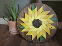 "Always keep your face toward the Sun(Flower) 18x18 inch Round Handmade wooden geometric style Sunflower art/ home decor. Each piece individually cut and hand painted. custom colors yellows and greens and staining in \"Dark Walnut\" and individual, unique design. 2 hanging brackets on back. This is an original piece but can be custom ordered for certain sizes and color specifications, just send a PM for customization. great for \"busy walls\", accent and photo walls or by itself, hang up or prop