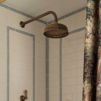 Rebecca Hughes on Instagram: "A look into the guest bathroom at our Kensington project. We love any opportunity to get creative with tiles and use a beautiful fabric as the outer shower curtain ✨

📷 - @astridtemplier 

 #RHI #londondesign #interiorstyle #interiordesign #design ​"