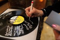 Signing a record instead of a guestbook is a unique way to remember this Sinatra soiree!